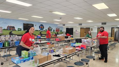 Stuff the Bus volunteers sorts supplies